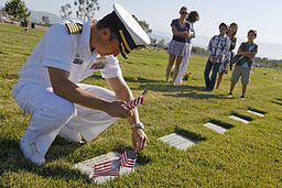 US_Navy_110530-N-HW977-025_Capt._Jay_Kadowaki_places_flags_at_the_grave_of_his_uncle,_U.S._Army_Spc._Robert_Kadowaki,_who_served_during_the_Vietnam